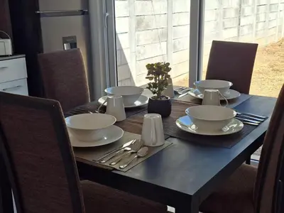 a table with bowls and plates on top of it at Nueva San Miguel - Casa Chaparrastique in San Miguel