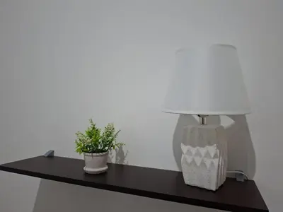 a table with a lamp and a potted plant on it at Nueva San Miguel - Casa Chaparrastique in San Miguel