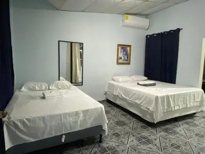two beds sitting next to each other in a room at Hostal Morales García in San Marcos