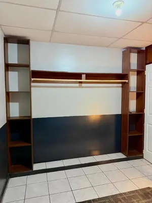 a room with a wall with shelves and a wall at Casa Armon - Frente a Estadio Cuscatlán in San Salvador
