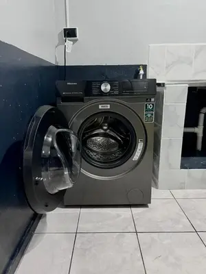 a washing machine with its door open in a room at Casa Armon - Frente a Estadio Cuscatlán in San Salvador