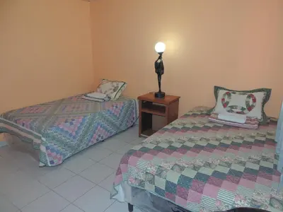 a bedroom with two beds and a lamp on a table at Hostal la Majada la Vida es Bella in San José La Majada