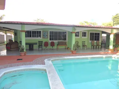 a swimming pool in front of a house at Hostal la Majada la Vida es Bella in San José La Majada