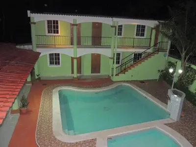 a house with a swimming pool at night at Hostal la Majada la Vida es Bella in San José La Majada