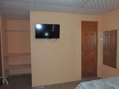 a room with a television on a wall at Hostal la Majada la Vida es Bella in San José La Majada