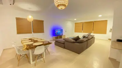 a living room with a couch and a table at Makai Beach Apartment in El Zapote