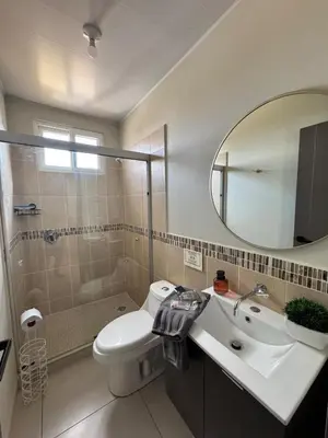 a bathroom with a sink and a toilet and a mirror at New, Peaceful Bonavista Home! in Zaragoza