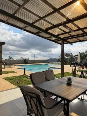 a patio with a table and chairs and a pool at New, Peaceful Bonavista Home! in Zaragoza