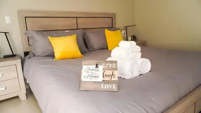 a bed with towels and a sign that says the greatest guest ever love at New, Peaceful Bonavista Home! in Zaragoza