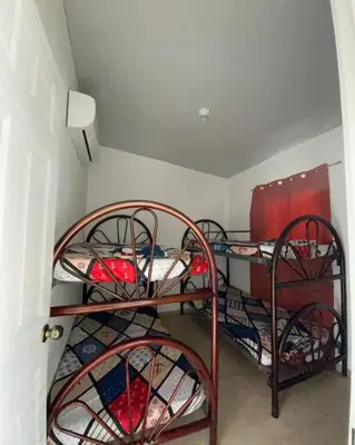 two iron bunk beds in a small room at Casa acogedora con piscina y seguridad las 24 horas in Ahuachapán