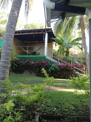 a house with a balcony and purple flowers at Casa de playa en lomas de san blas in Playa San Blas