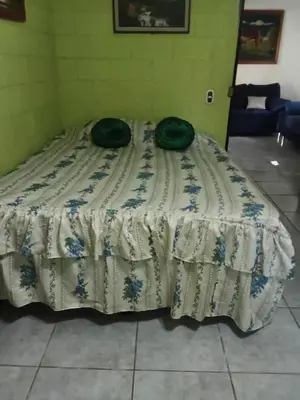 a bed with two pillows sitting on top of it at Casa de playa en lomas de san blas in Playa San Blas