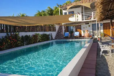 a swimming pool in front of a house at Beachfront House The Hope in San Luis