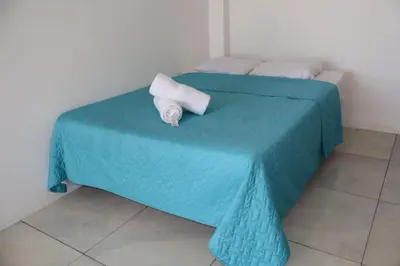 a blue bed with a towel on top of it at Beachfront House The Hope in San Luis