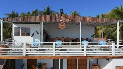 a house with a deck with chairs on it at Beachfront House The Hope in San Luis