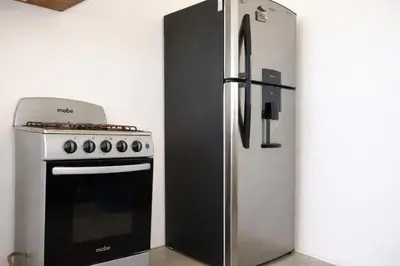 a refrigerator and a stove in a kitchen at Beachfront House The Hope in San Luis