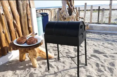 a grill with a plate of food on a table at Beachfront House The Hope in San Luis