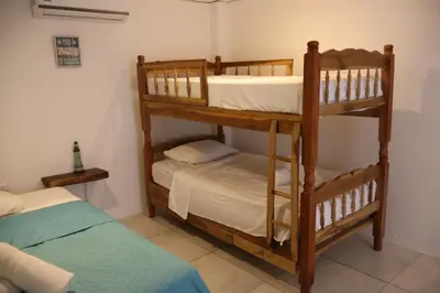 two bunk beds in a room with a bed at Beachfront House The Hope in San Luis