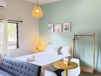a small bedroom with a bed and a table at Cozy Loft with pool and beach in Surf City in La Libertad