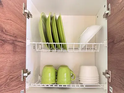 a cupboard with green dishes and plates in it at Cozy Loft with pool and beach in Surf City in La Libertad