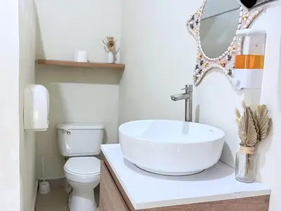 a bathroom with a sink and a toilet at Cozy Loft with pool and beach in Surf City in La Libertad