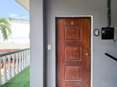 a wooden door in a room with a balcony at Cozy Loft with pool and beach in Surf City in La Libertad