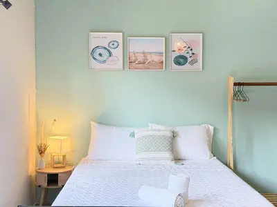 a bedroom with a bed with four pictures on the wall at Cozy Loft with pool and beach in Surf City in La Libertad