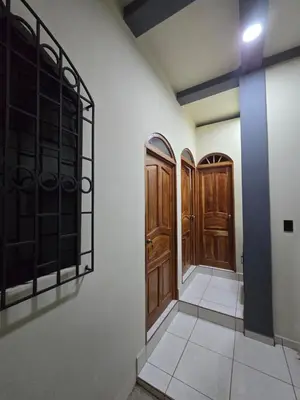 a hallway with wooden doors in a room at The Stone Way Suite in Juayúa
