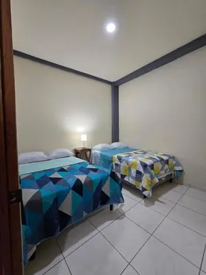a bedroom with two beds in a room at The Stone Way Suite in Juayúa