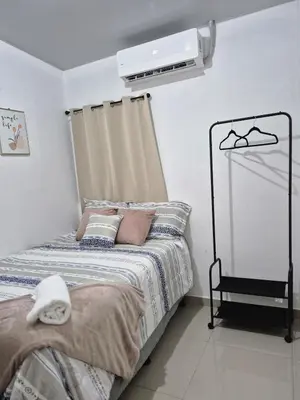 a bedroom with a bed and a fan at Casa Mia en San Miguel