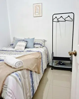 a bedroom with a bed with blue pillows at Casa Mia en San Miguel