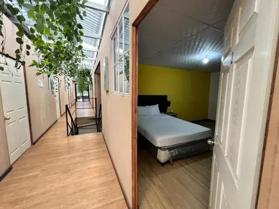 a bedroom with a bed in the middle of a hallway at Hostal Noche de Luna in San Salvador