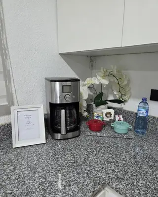 a microwave sitting on a kitchen counter next to a picture at Casa Luna Villa Verde State in Santa Ana
