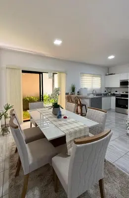 a dining room and kitchen with a table and chairs at Casa Luna Villa Verde State in Santa Ana