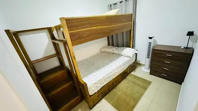 a bedroom with a wooden bunk bed with a dresser at Casa de Sasha