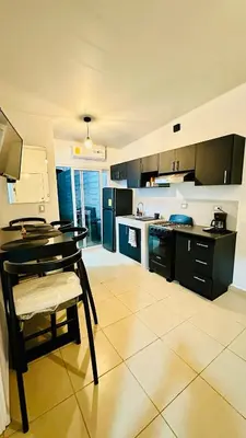 a large kitchen with a table and a counter top at Casa de Sasha