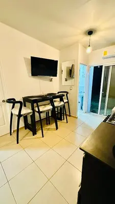 a dining room with a black table and chairs at Casa de Sasha