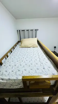 a bed in a room with a wooden frame at Casa de Sasha