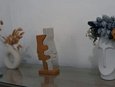 a couple of vases and a vase with flowers at La casita de oly in Concepción de Ataco