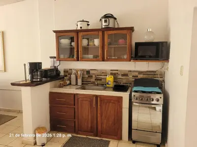 a kitchen with a sink and a microwave at La casita de oly in Concepción de Ataco