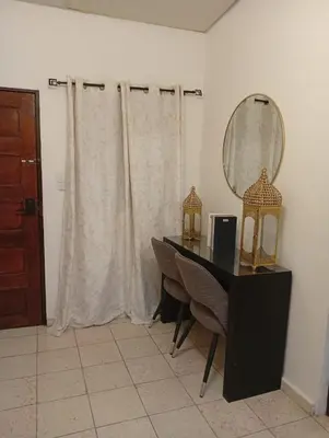 a room with a desk and a mirror and a table at La casita de oly in Concepción de Ataco
