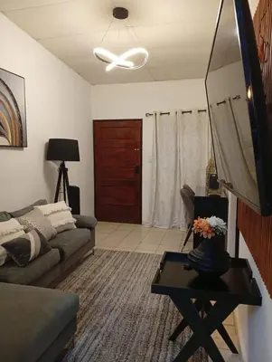 a living room with a couch and a ceiling fan at La casita de oly in Concepción de Ataco