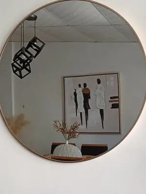 a mirror hanging on a wall with a picture at La casita de oly in Concepción de Ataco