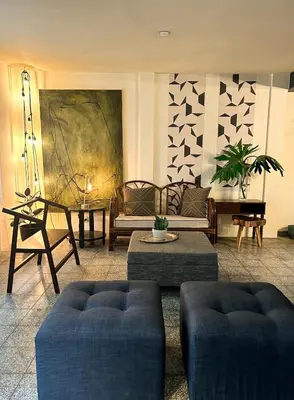 a living room with two couches and a table at Casa Maruca- 2 bedrooms Home for 5 Guests - A charming getaway near downtown & financial hub area! in San Salvador
