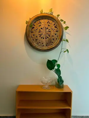a clock on a wall above a table with a plant at Casa Maruca- 2 bedrooms Home for 5 Guests - A charming getaway near downtown & financial hub area! in San Salvador