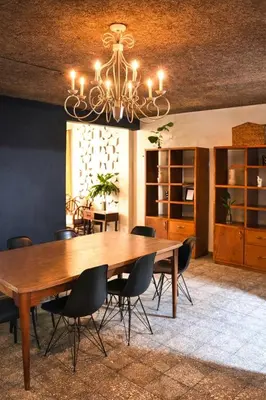 a dining room table with chairs and a chandelier at Casa Maruca- 2 bedrooms Home for 5 Guests - A charming getaway near downtown & financial hub area! in San Salvador