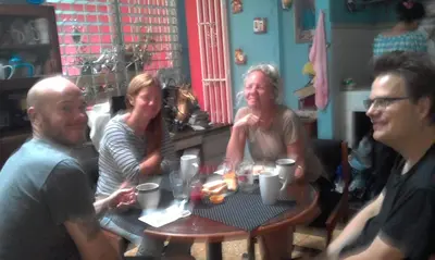 a group of people sitting around a table at Casa Blanca Tu Casa in Santa Ana