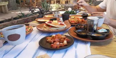 a table with plates of food on top of it at Casa 1800 Suchitoto Boutique in Suchitoto