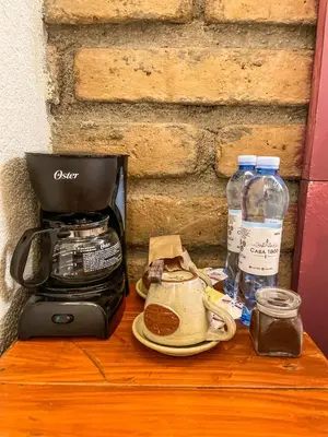 a coffee maker and a toaster on a wooden table at Casa 1800 Suchitoto Boutique in Suchitoto