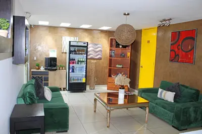 a living room with two green couches and a coffee table at Terra Bella Hotel Boutique in San Salvador